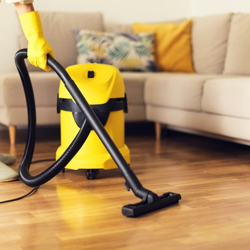 woman cleaning sofa with yellow vacuum cleaner copy space cleaning service concept woman cleaning sofa with yellow vacuum cleaner copy space cleaning service concept